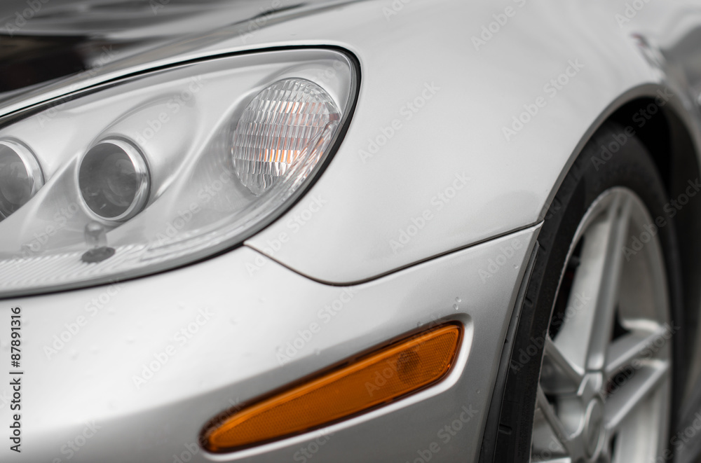 Fototapeta Close-up view of silver sports car headlight.
