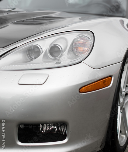 Close-up view of silver sports car headlight. © M-Production