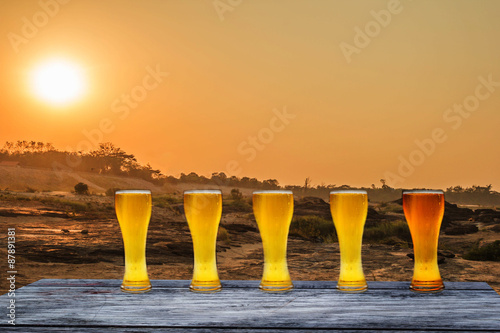 Beer in glass on a wooden table background 