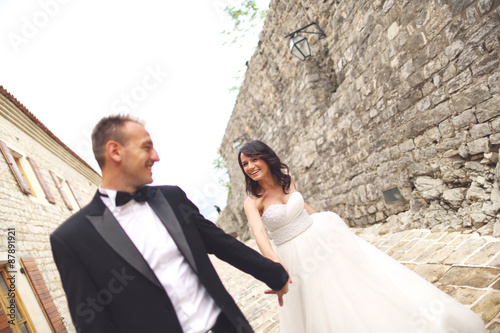 Happy bridal couple holding hands © hreniuca
