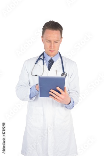 Serious doctor using a digital tablet