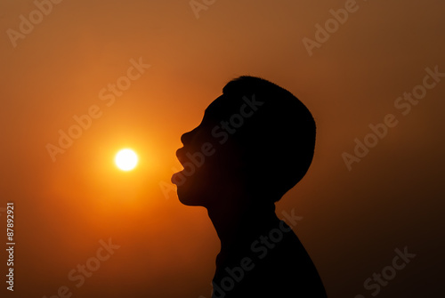 Young boy eating the sun