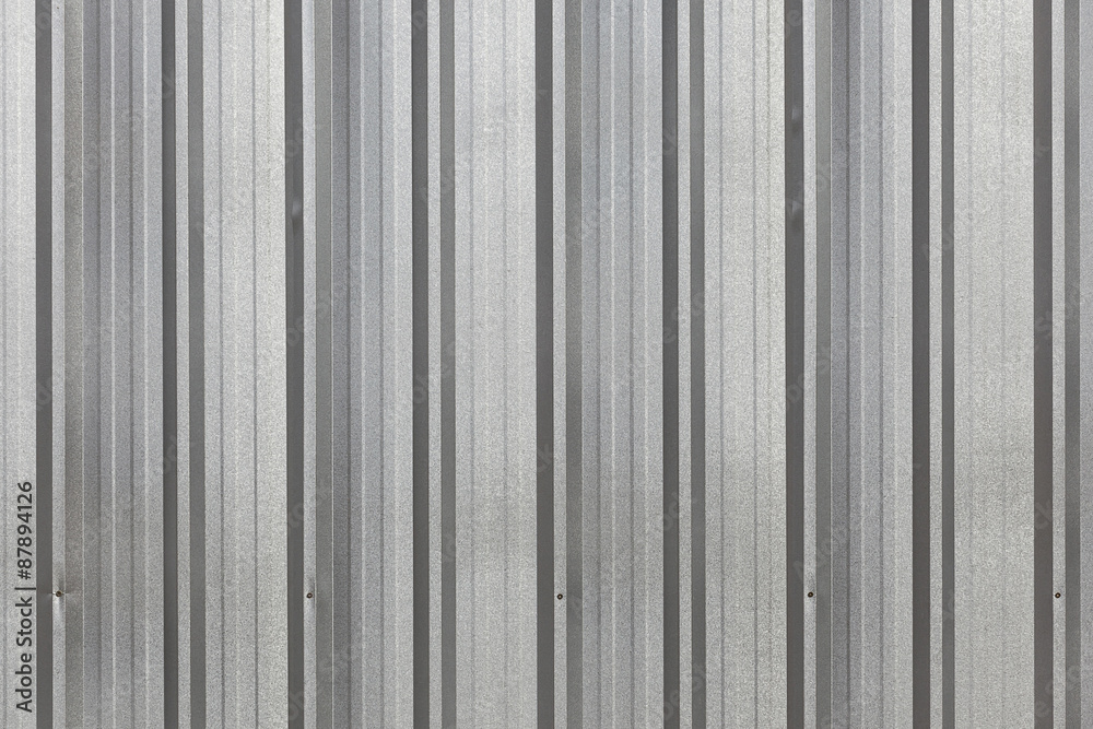 The corrugated grey metal wall background. The corrugated grey metal wall background.
