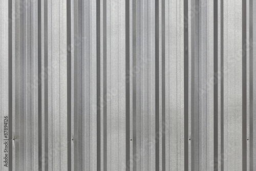The corrugated grey metal wall background.