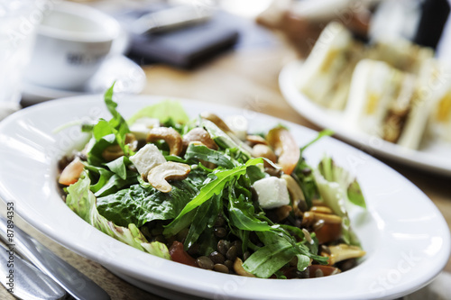 close up of salad of vegetables and cashew nuts in plate 