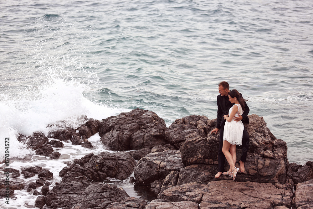 Bride and groom embracing at the beach Bride and groom embracing at the beach