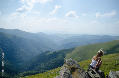 Young blond woman meditating in the beautiful mountain landscape © dima4to