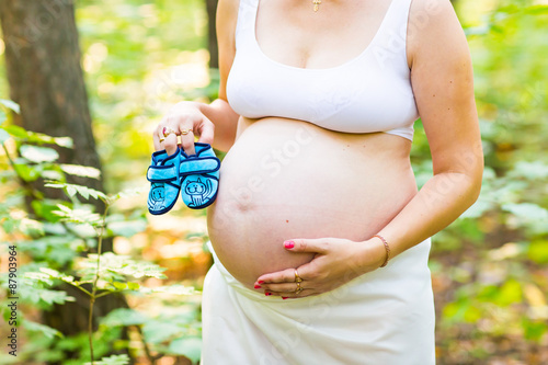 pregnant woman with a baby's bootees