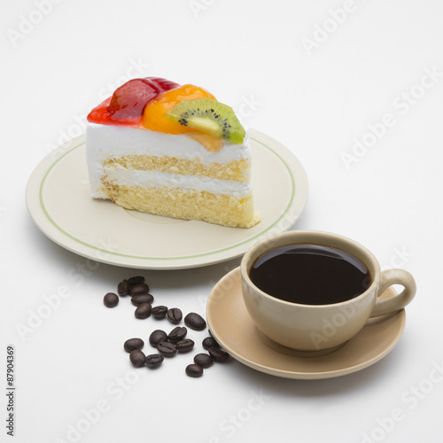 cup of coffee and delicious cake on white background