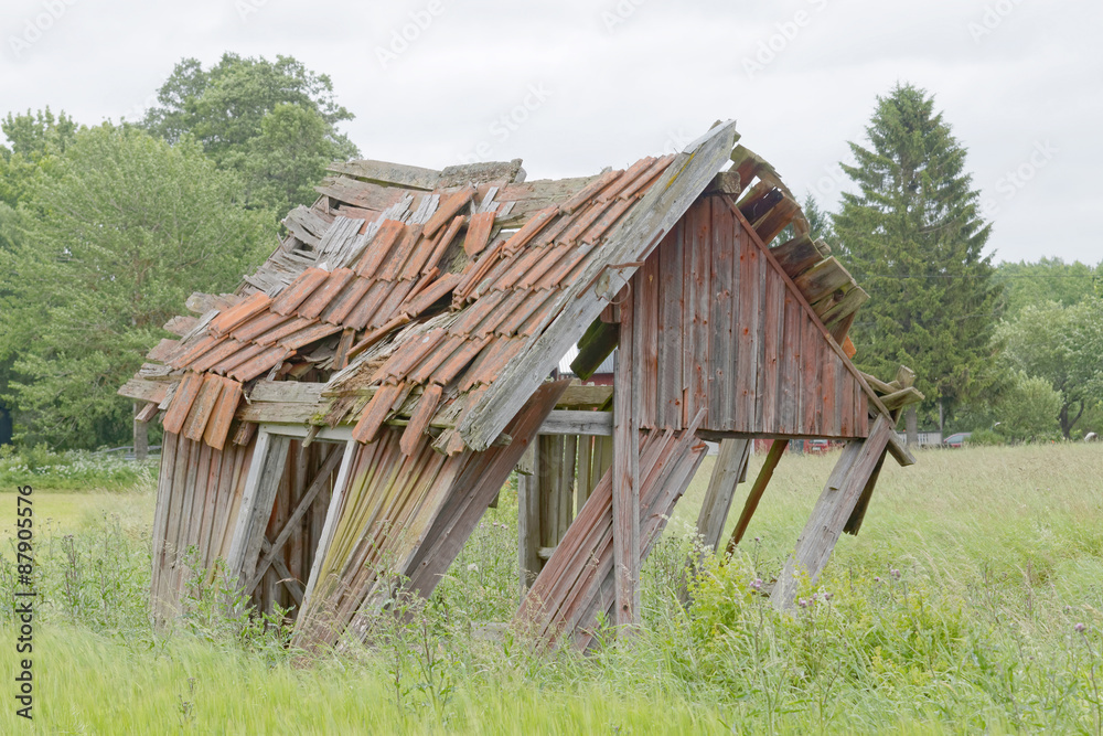 Tumbledown barn on a field Tumbledown barn on a field