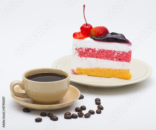 cup of coffee and delicious cake on white background
