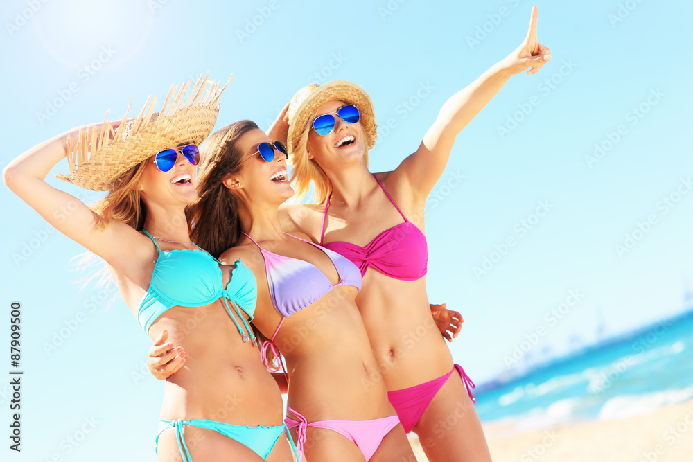 Group of women pointing at something on the beach