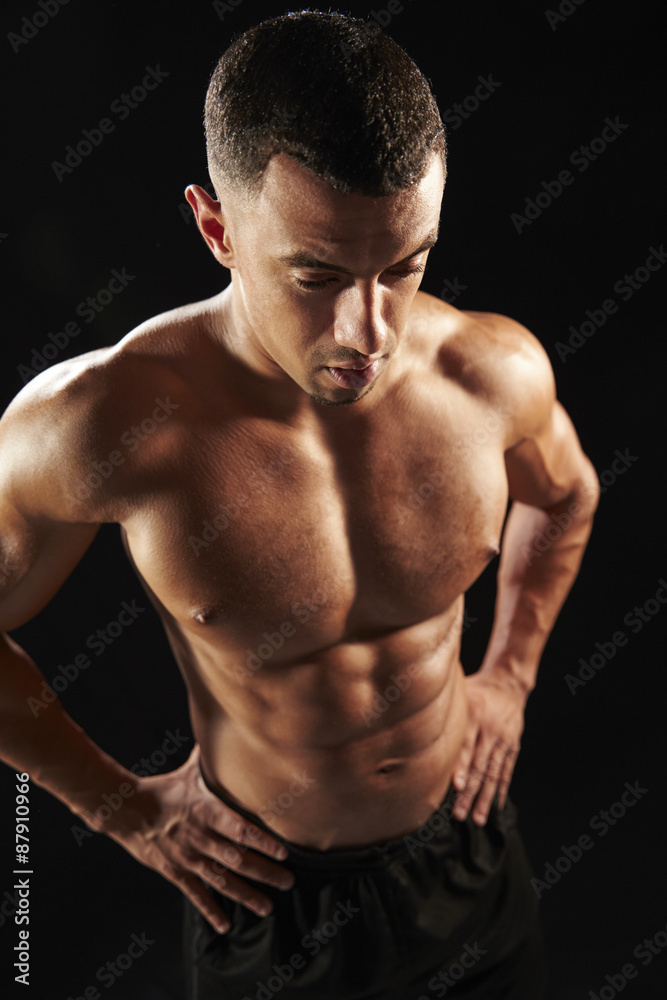 Male bodybuilder with hands on hips, elevated view