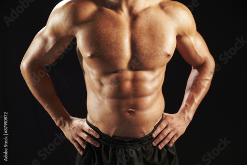 Male bodybuilder torso, front view, crop