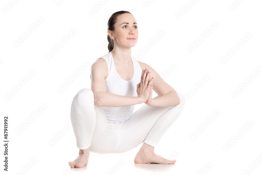 Female sitting in yoga squat