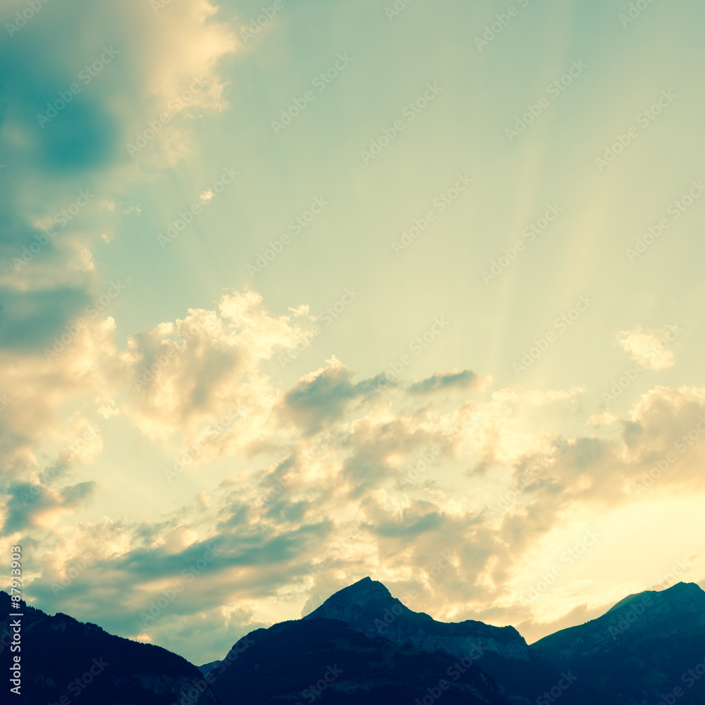 The sun goes down to the tops of mountains. Filter soft light. Photo, abstract landscape