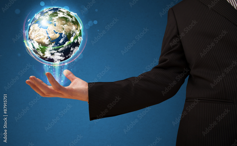 Businessman holding a glowing earth globe Businessman holding a glowing earth globe
