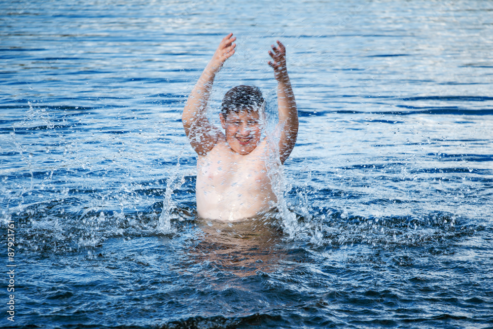 Boy playing in the water.