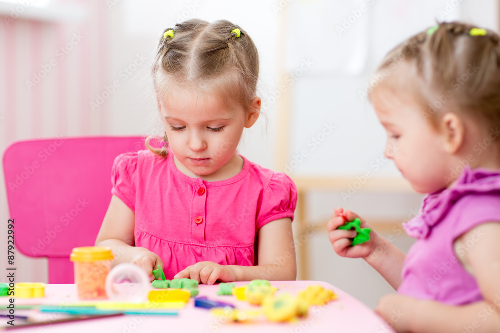 Little girls creating from play dough Little girls creating from play dough