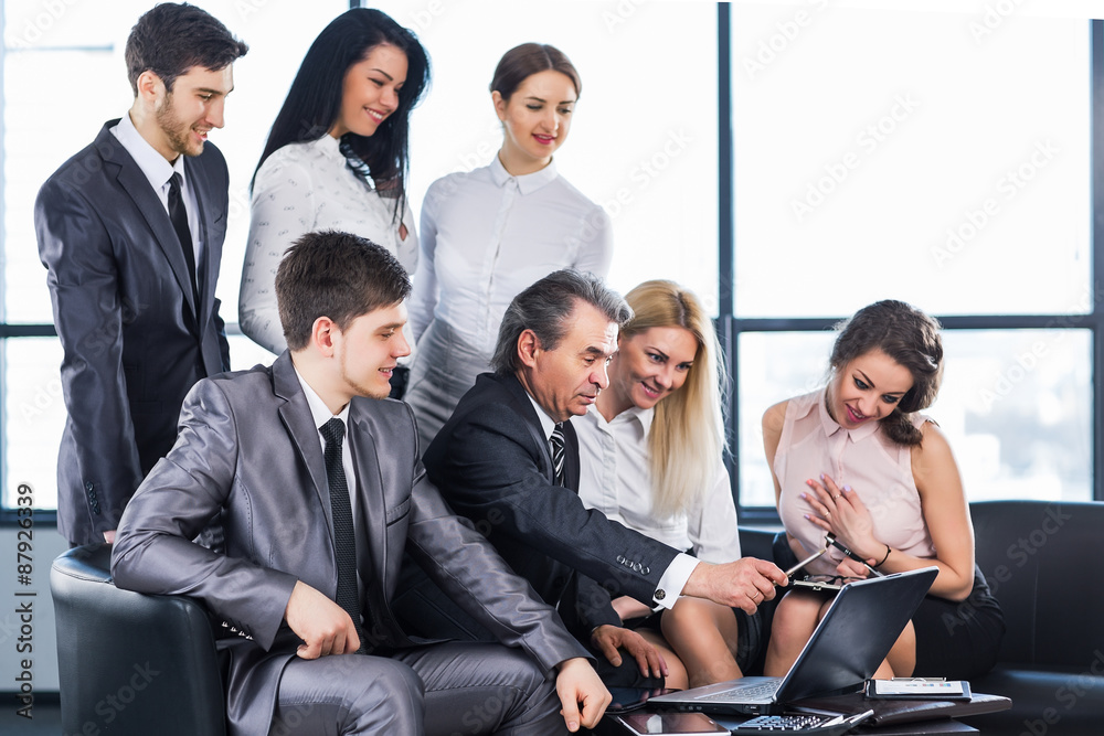 A group of businessmen discussing the policy of the company in t A group of businessmen discussing the policy of the company in t