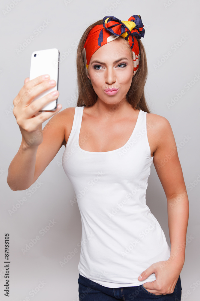 Pouting pretty woman taking a selfie with mobile phone Pouting pretty woman taking a selfie with mobile phone