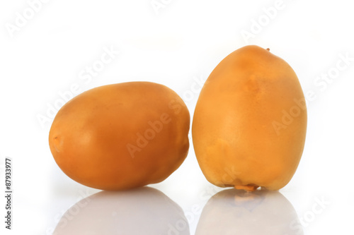 Yellow Dates fruits on white Background photo