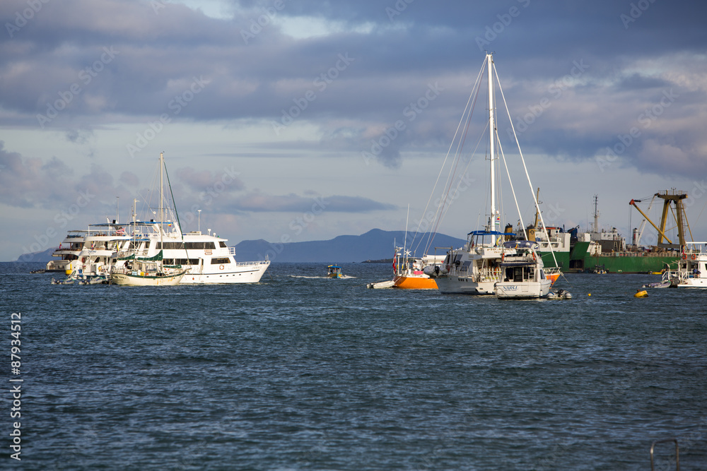 Fototapeta premium Sunset and cruise ships in Galapagos Islands