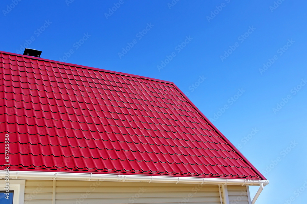 New red roof tiles on blue sky background.