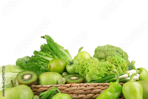 Fresh green food in wicker basket isolated on white