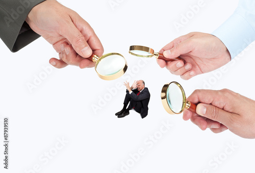 Hands with magnifier glasses looking, studying or selecting a person