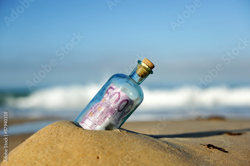 500 euro note in a bottle found on the beach, southern Europe