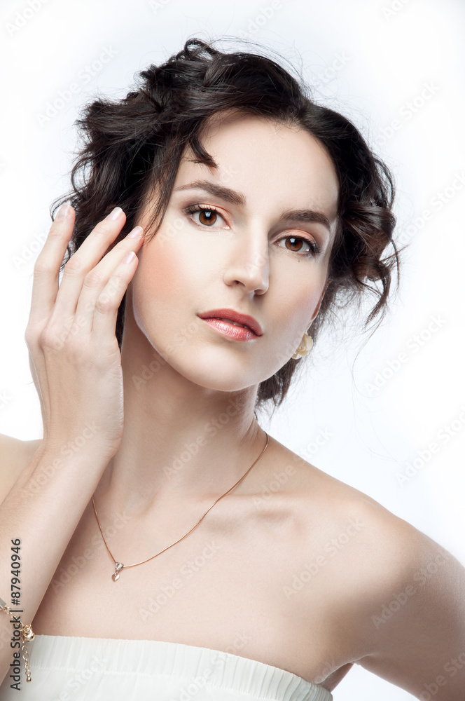 Naklejka premium Studio portrait of a beautiful brunette with evening hairdo and