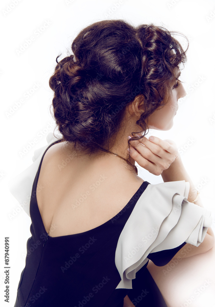 Studio portrait of a beautiful brunette with evening hairdo and Studio portrait of a beautiful brunette with evening hairdo and
