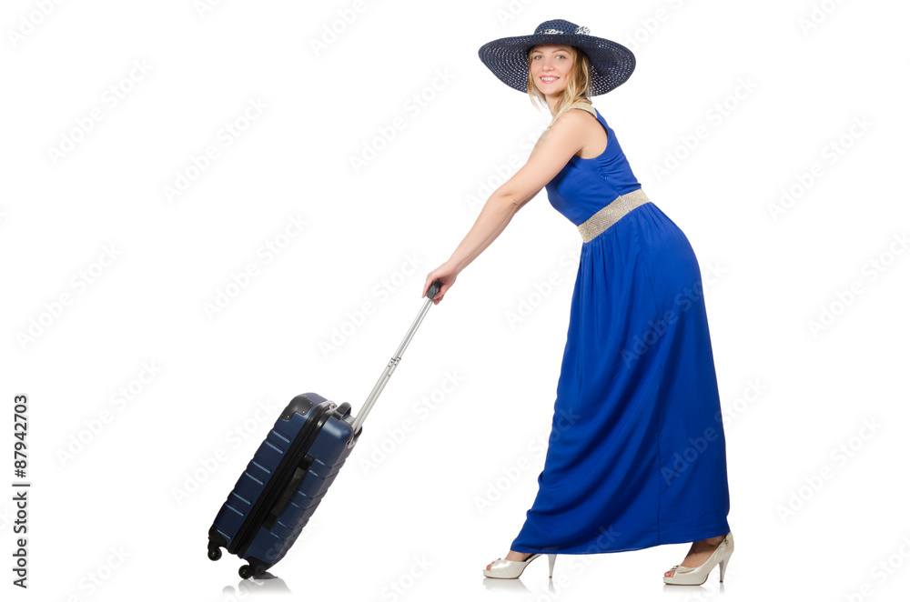 Young woman in blue dress and suitcase isolated on white