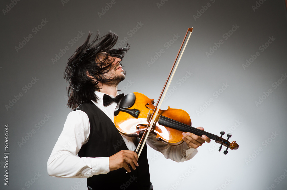 Fototapeta premium Man playing violin in musical concept