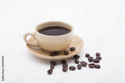 cup of coffee and delicious cake on white background