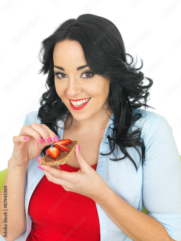 Young Woman Eating a Cracker with Chocolate Spread and Fresh Strawberries Young Woman Eating a Cracker with Chocolate Spread and Fresh Strawberries
