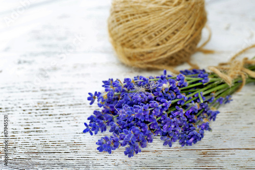 Fresh lavender and rope on wooden background