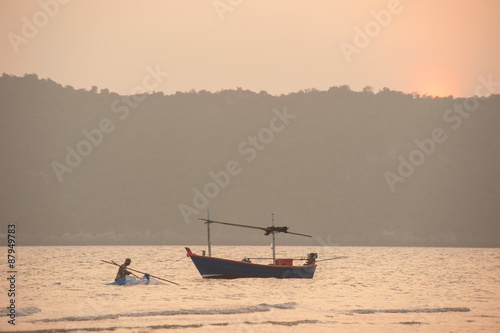 silhouette of fishermen with sunset in the background