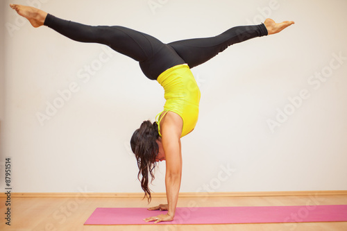 Headstand leg split in a yoga studio