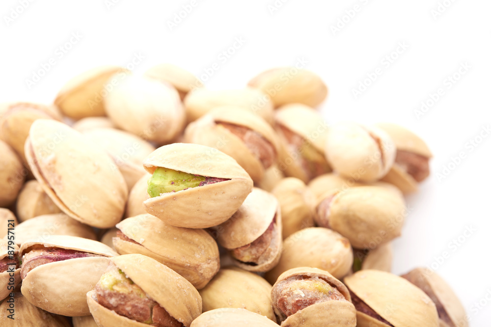 Heap of pistachios nuts isolated on the white Heap of pistachios nuts isolated on the white
