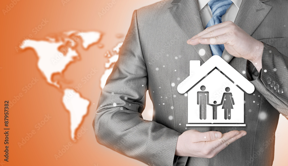 businessman protecting family in home with hands businessman protecting family in home with hands