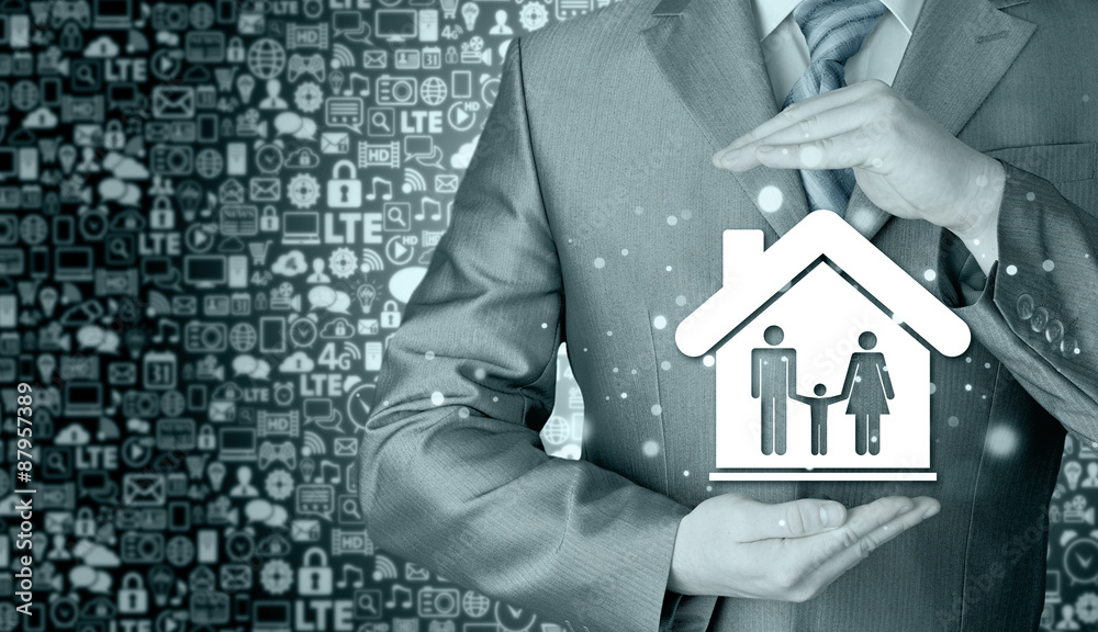 businessman protecting family in home with hands businessman protecting family in home with hands