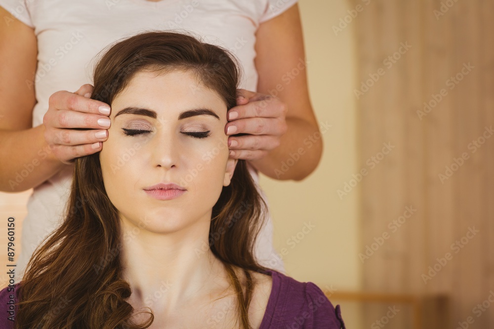 Young woman having a reiki treatment Young woman having a reiki treatment