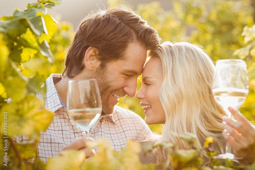 Fototapeta premium Young happy couple holding glasses of wine