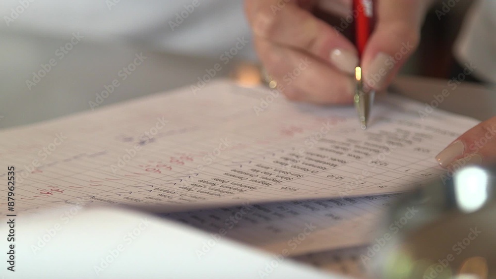 Member of staff checking name on list during a german golf tournament.