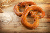 Freshly baked pretzels on  wooden table.