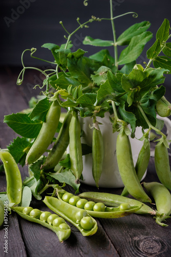 Ripe Green peas on wooden table.