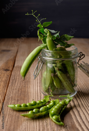 Ripe Green peas on wooden table.