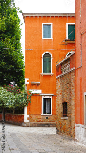Alley with orange ancient building © polarbearstudio